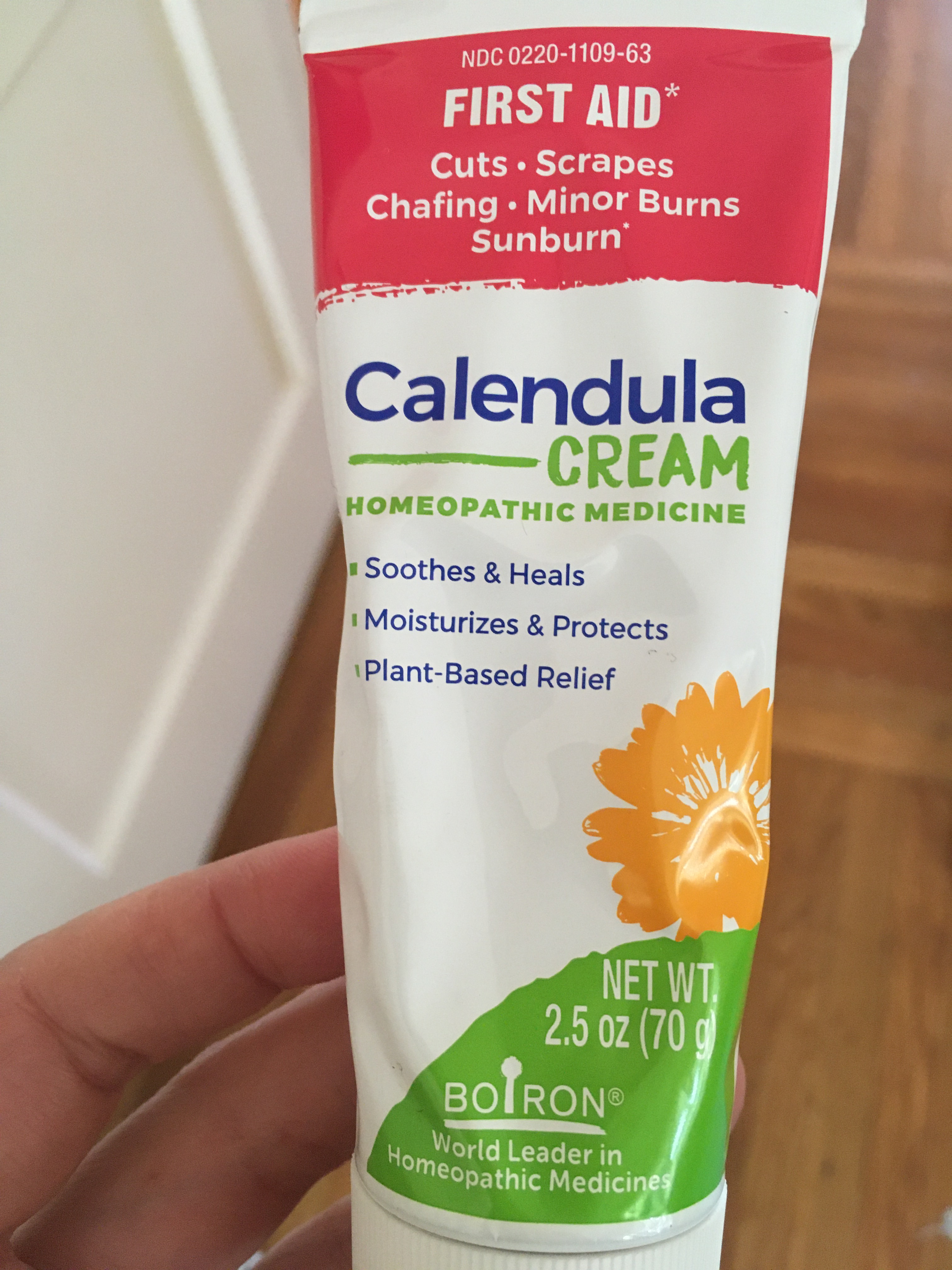 Photo of hand holding tube of Calendula Cream.