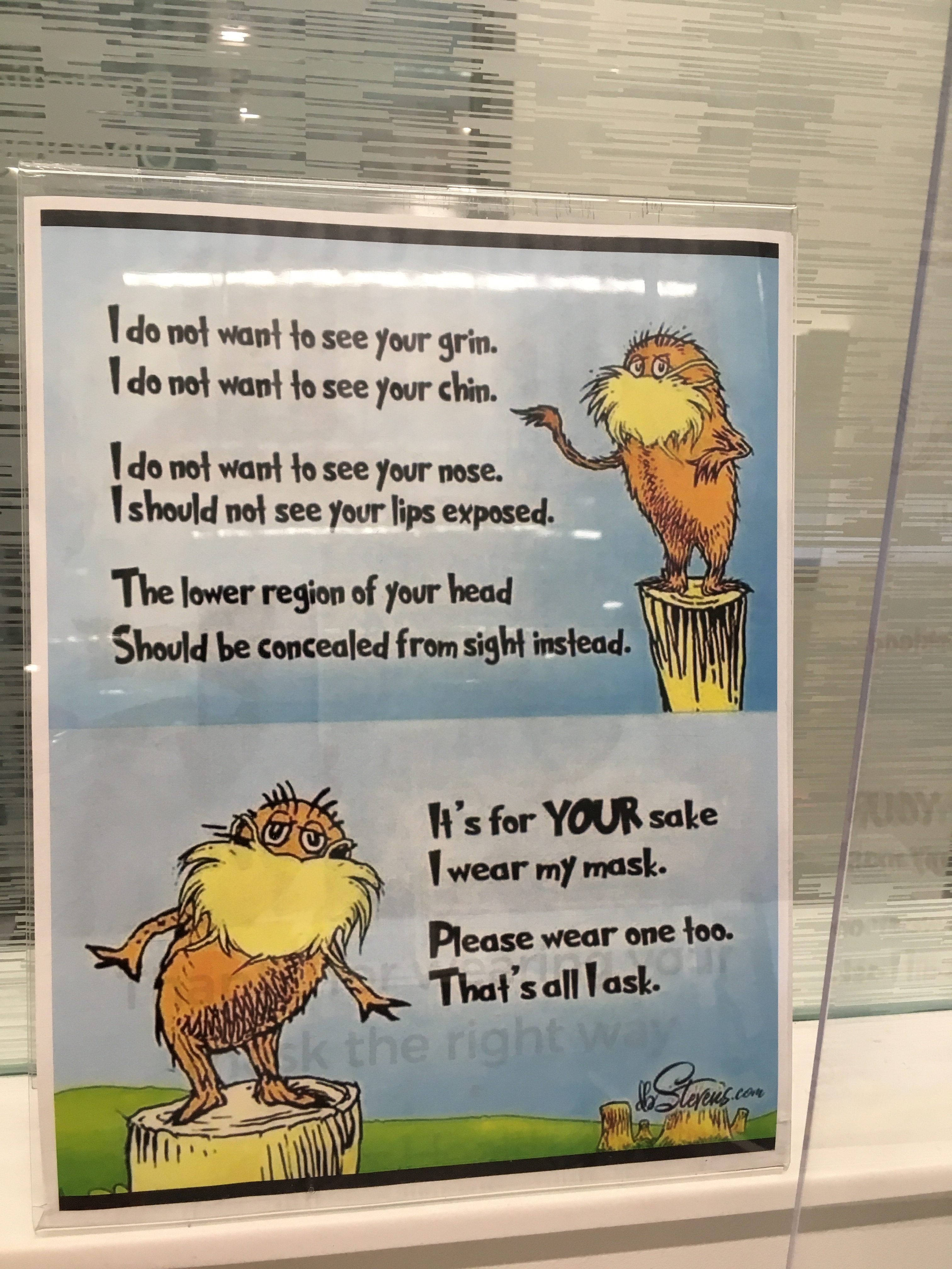 Photo of a sign encouraging mask use, a Lorax-themed rhyming poem.